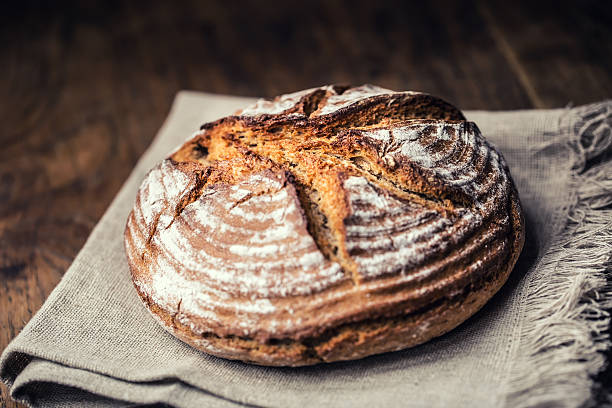 istock Bread.Fresh round crisp bread with caraway on wooden table 637713480