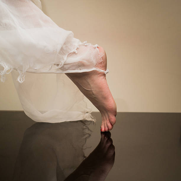 istock Close-up classic ballerina's legs, dance barefoot. 637713510