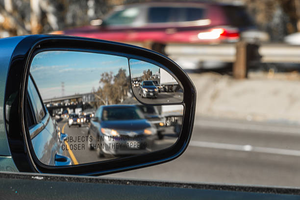 Objects in mirror are closer than they appear on car stock photo
