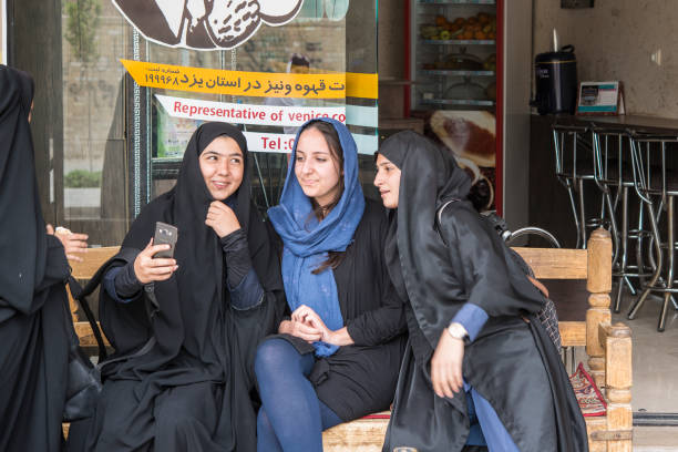 local and foreign women taking a selfie, yazd, iran - iraanse cultuur stockfoto's en -beelden