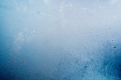 Close-up of water drops on a window, Natural water drops on glass, winter condensation