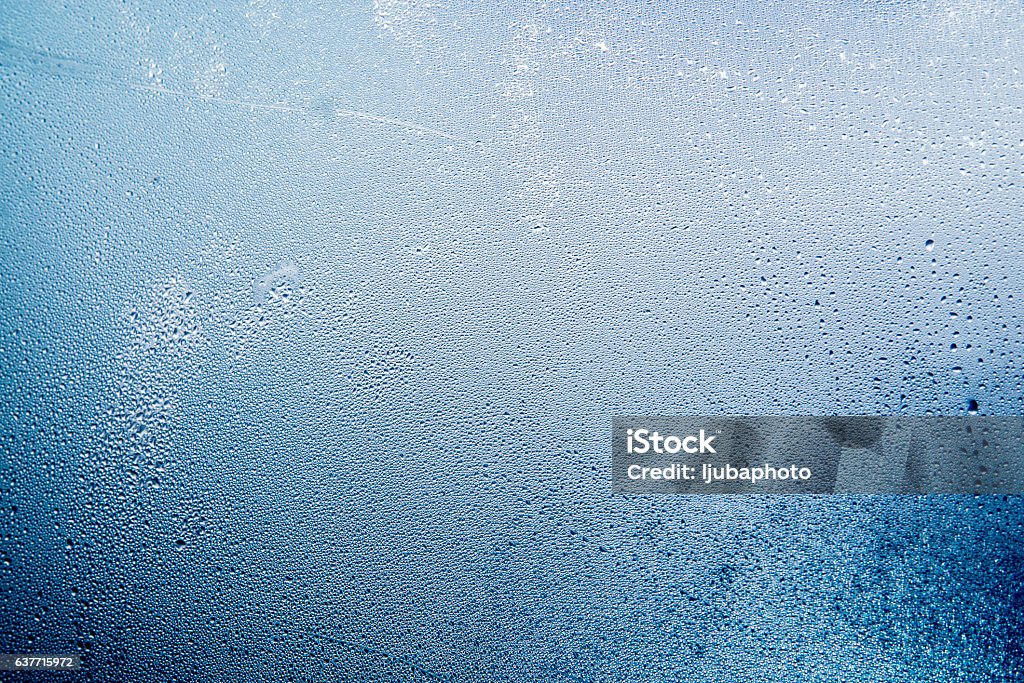 Natural water drops on glass, winter condensation Close-up of water drops on a window, Natural water drops on glass, winter condensation Glass - Material Stock Photo