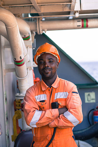 istock african seaman standing in coverall and helmet 637717272