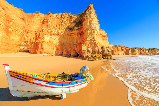 Fishing boat in Portimao, Algarve region, Portugal Fishing boat on a Praia da Rocha in Portimao, Algarve region, Portugal algar de benagil photos stock pictures, royalty-free photos & images