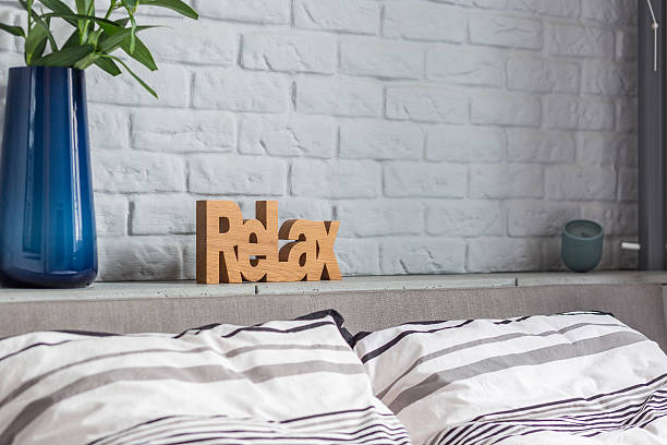 Stylish decorations in new bedroom with double bed and brick wall