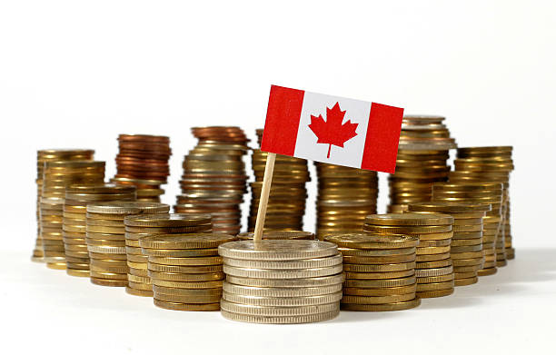 istock Canada flag waving with stack of money coins 637717818