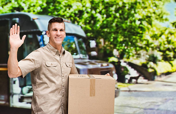 istock Smiling worker waving hand outdoors 637718482
