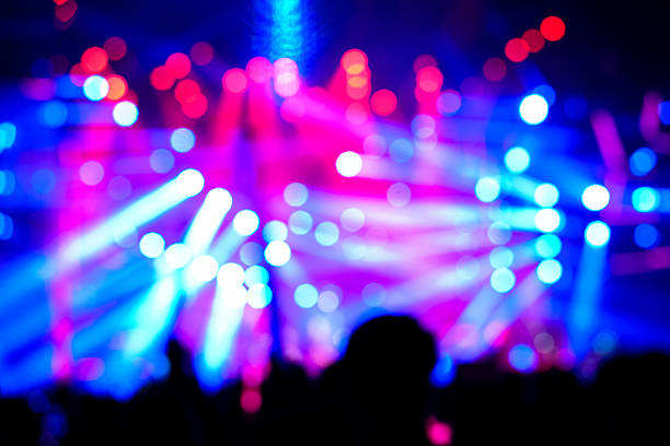 Defocused entertainment concert lighting on stage, blurred disco party and Concert Live.