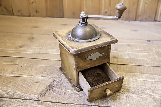istock Vintage manual coffee grinder standing on a wooden surface 637719388