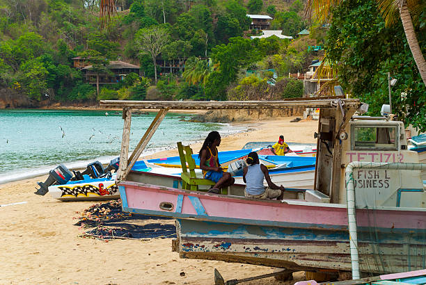 Castara bay beach, Tobago Castara, Tobago - May 2, 2016: People on the Castara bay beach in Tobago, Trinidad and Tobago, Caribbean trinidad culture stock pictures, royalty-free photos & images