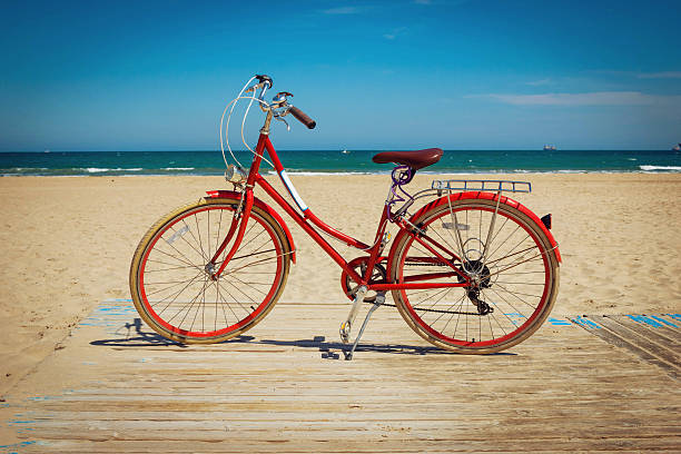 istock Retro red bicycle on beautiful beach background 637720848