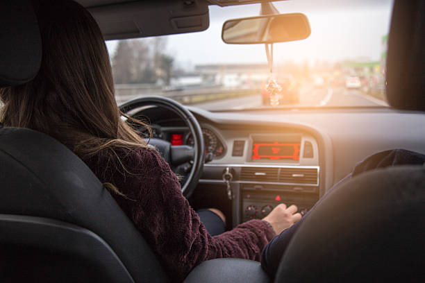istock Female changing gears in a car 637725136