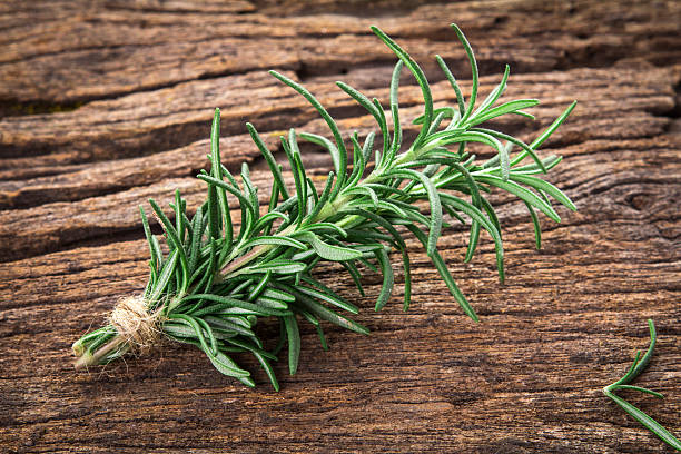 istock Fresh green Rosemary bound on a wooden board 637725884