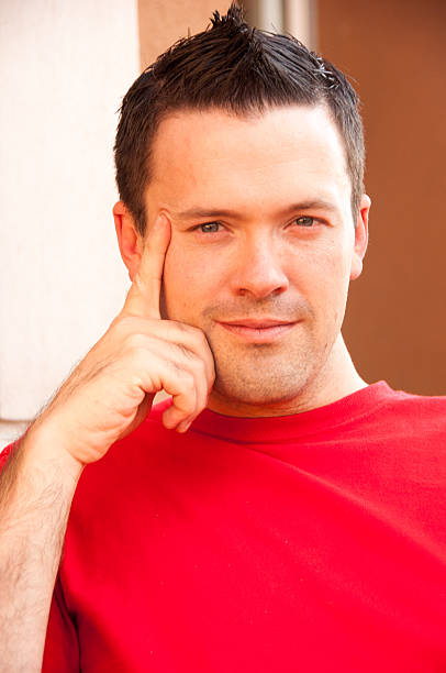 istock Handsome gay man sits in a chair with right hand next 637728100