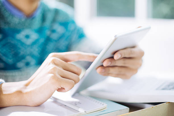 istock young asian man studying by tablet in classroom 637729480