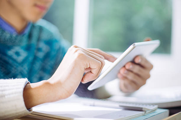 istock young asian man studying by tablet in classroom 637729530