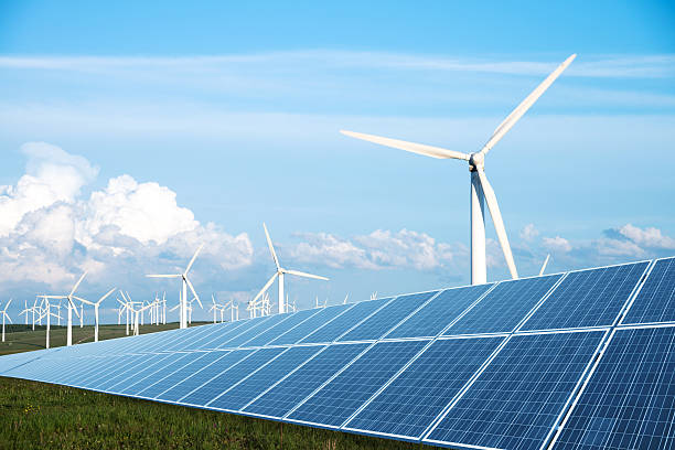 solar panel in green lawn with wind power station