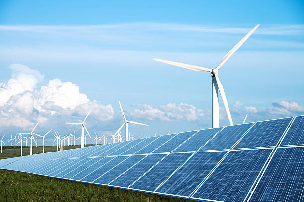 solar panel in green lawn with wind power station solar panel in green lawn with wind power station in blue sky alternative energy stock pictures, royalty-free photos & images