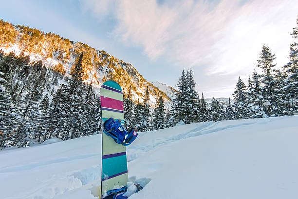 istock Snowboard standing in snow in mountains on road frirayd 637732342