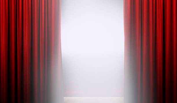 istock Open red curtain on stage with bright spotlight 637737960