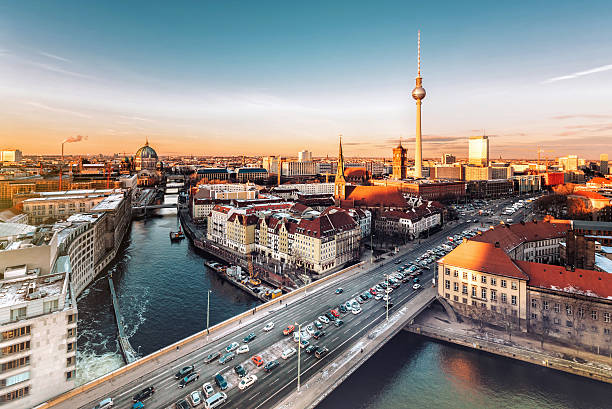 berlin cityscape with television tower under at sunset hour