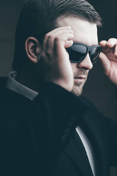 istock trendy man trying on sunglasses 637739544