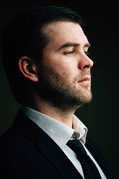 istock successful businessman on a dark background 637739794
