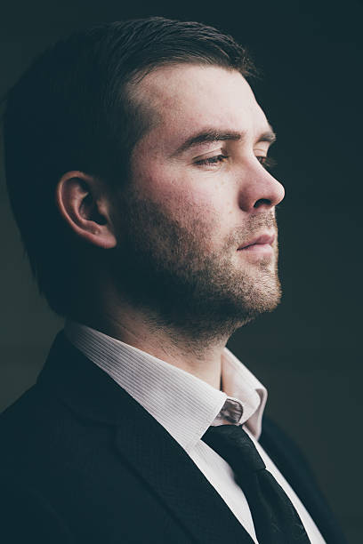 istock successful businessman on a dark background 637740264