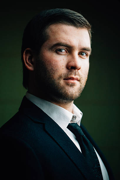 istock successful businessman on a dark background 637740514