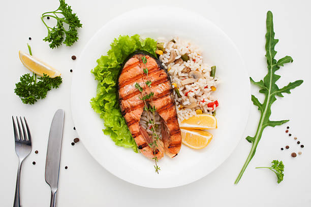 istock Grilled salmon with rice and cutlery flat lay 637740588