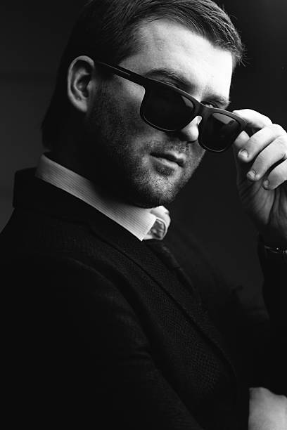istock man in sunglasses lowered a little in the dark room 637742714