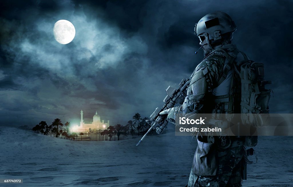 US Army Green Beret Green Berets US Army Special Forces soldier patrolling desert. Cloudy night, full moon, oasis palace Army Stock Photo