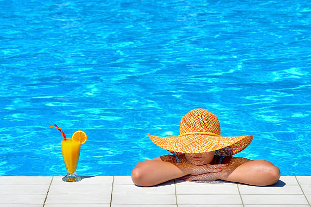 istock Real female beauty relaxing at swimming pool 637745726