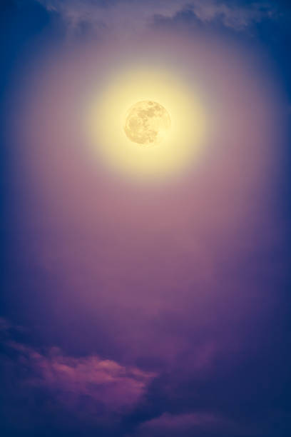 istock Nighttime sky with clouds and bright full moon with shiny. 637747284