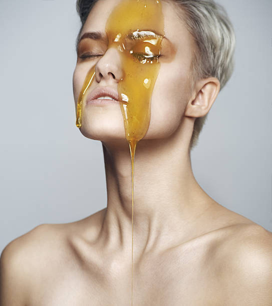 istock Beautiful woman with a honey on her face 637747414