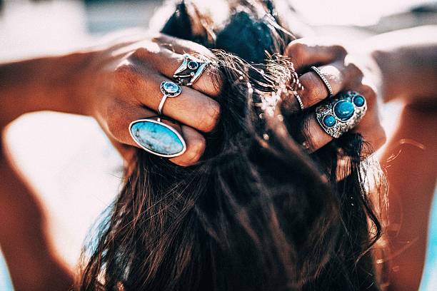 Close up of Women with bohemian style jewelery rings on Close up of Women with bohemian style jewelery rings on hands bohemian fashion stock pictures, royalty-free photos & images