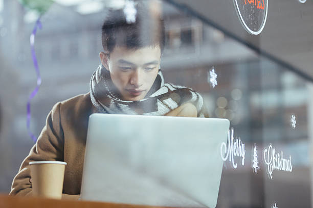 istock young asian man with laptop in cafe 637748998