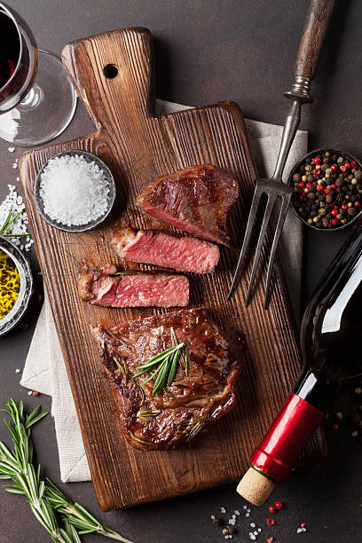 istock Grilled ribeye beef steak with red wine 637750750
