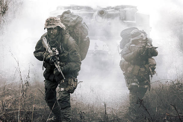 Jagdkommando soldiers Austrian special forces Jagdkommando soldiers Austrian special forces and tank moving on terrain in the fog. They are ready to face the enemy. NATO military power concept artillery photos stock pictures, royalty-free photos & images