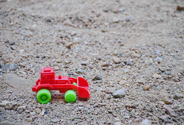 istock Children's toy red excavator car on playground 637753474