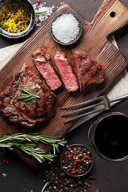 istock Grilled ribeye beef steak with red wine 637753674