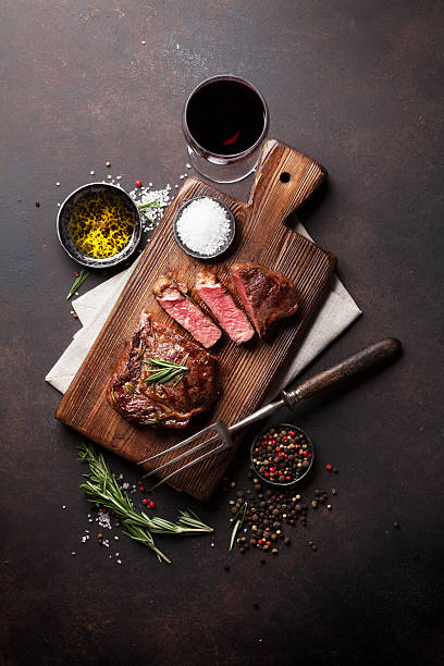 istock Grilled ribeye beef steak with red wine 637753784