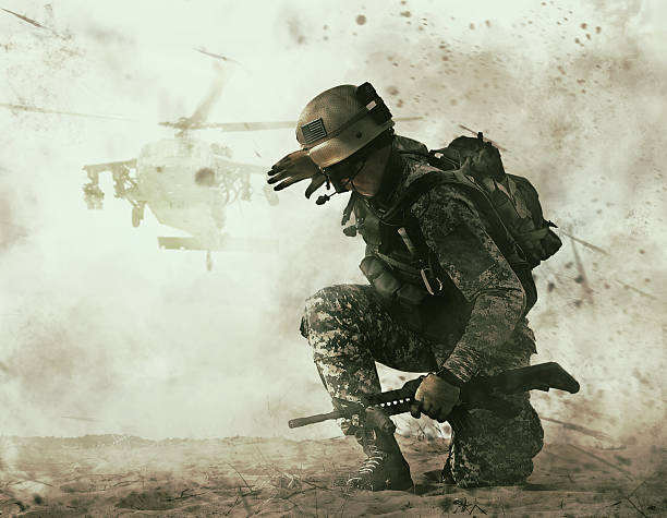 US soldier and combat helicopter approaching US soldier in the desert during the military operation turning to combat helicopter approaching covering his eyes. Backup is coming battlefield photos stock pictures, royalty-free photos & images