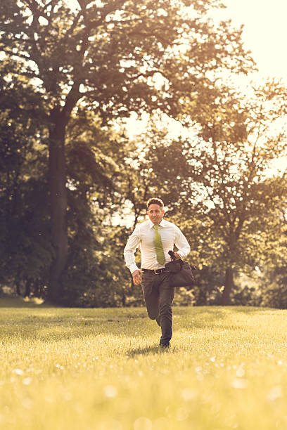 istock Happy businessman rushing to work through the park. 637754152