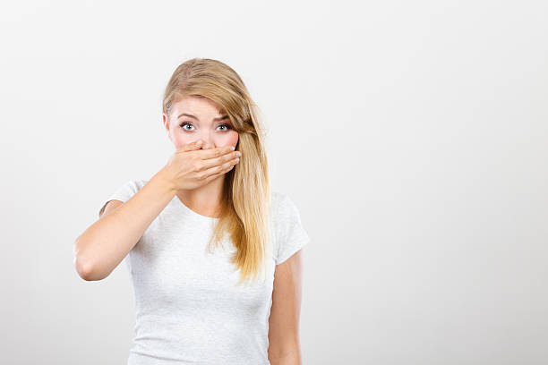 istock Ashamed woman having hand on mouth 637755618