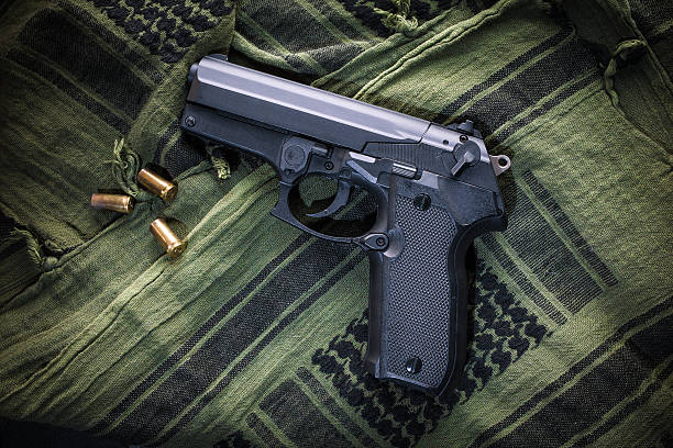 istock Gun on Green Kefiah 637755922