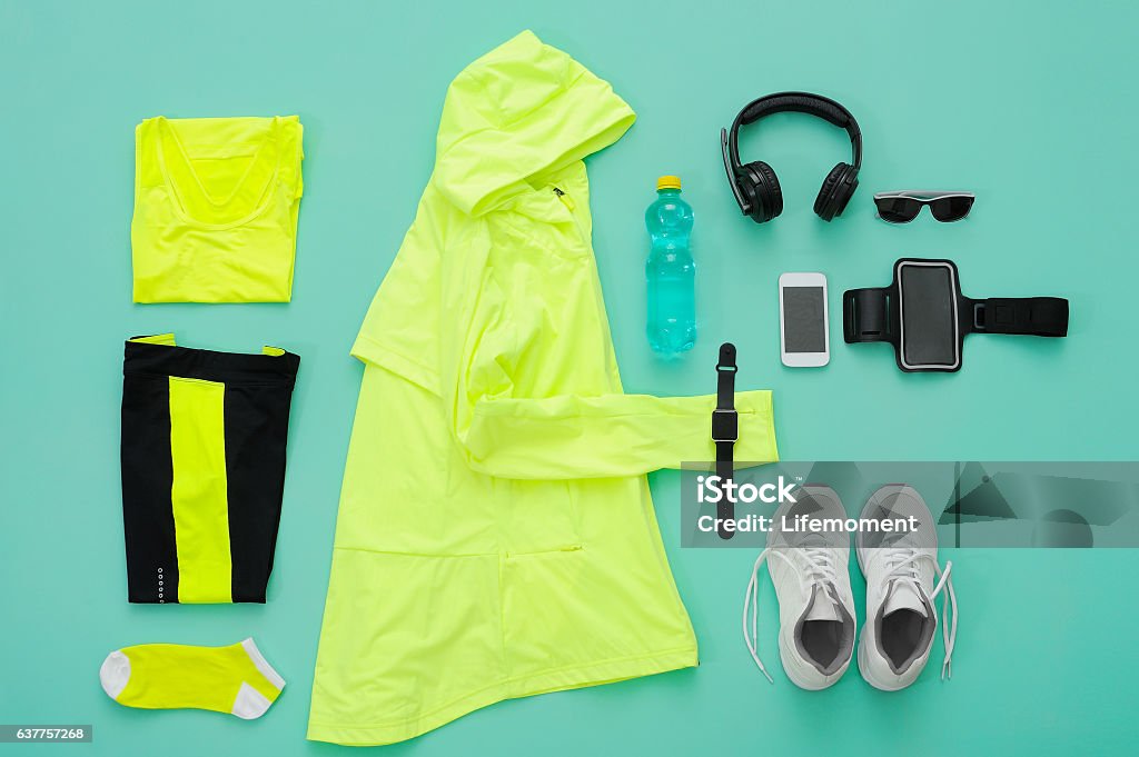 Sports clothing and accessories on turquoise background. Sports clothing and accessories on turquoise background. The concept of a healthy lifestyle. Preparation of sports clothing to training. Still Life Stock Photo