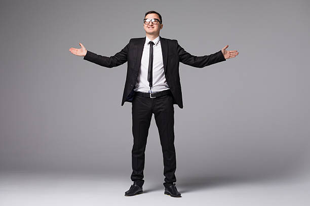istock Young businessman in suit hands raised up isolated 637761560