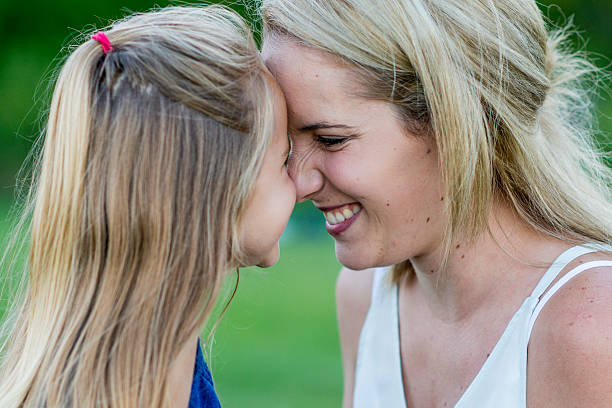 istock Mother and Daughter Giggling Together 637763846