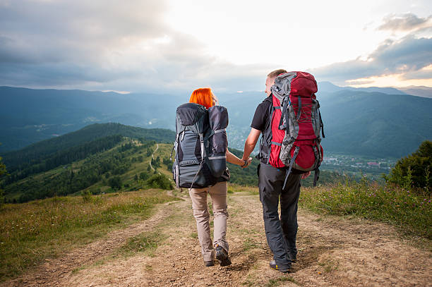 istock Back view of hiker family is walking, holding hands, smiling 637764532